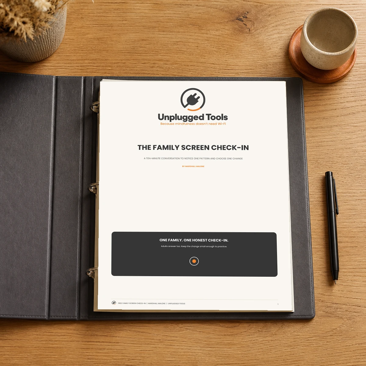 Printed Free Family Screen Check-In pages in an open charcoal three-ring binder on a wooden table.