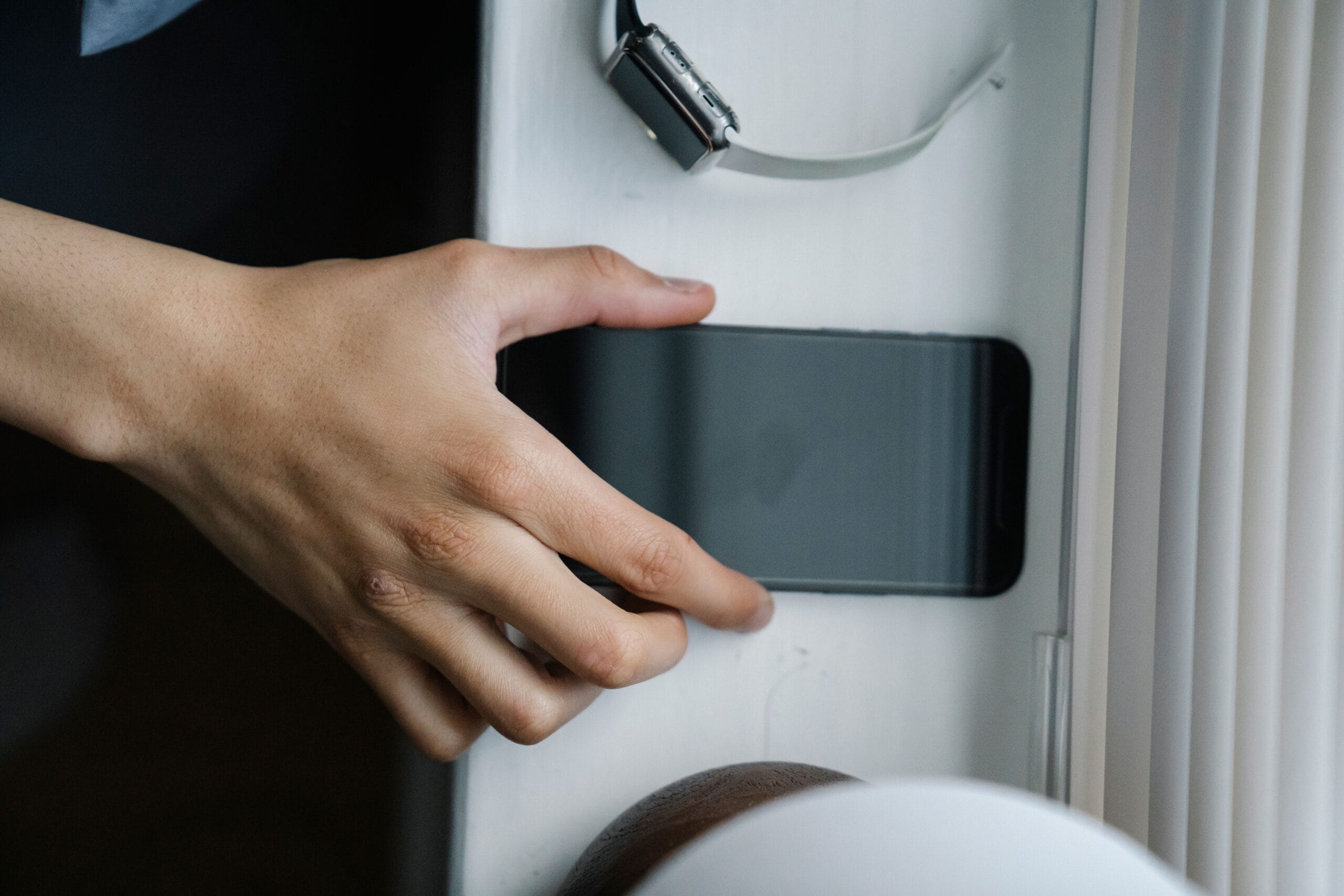 Man reaching for cell phone.